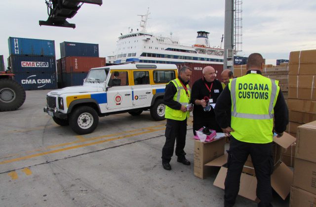 Albanian customs staff checking crates.