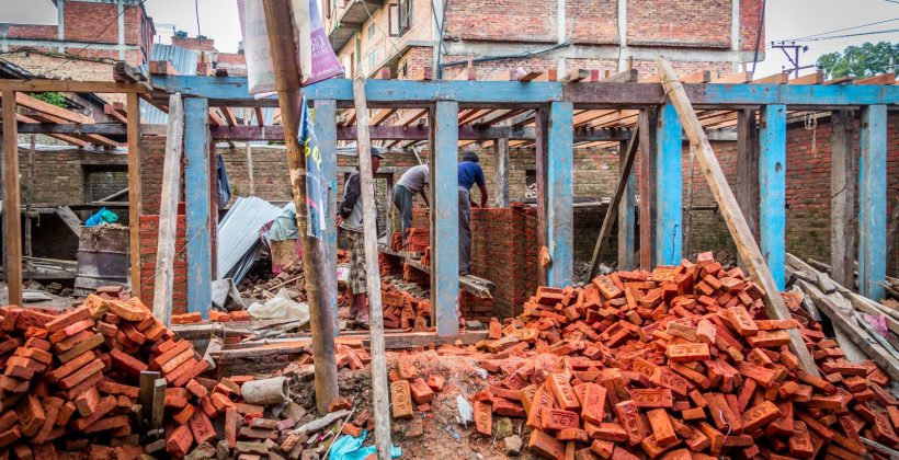 Destroyed dwelling being repaired in Nepal.