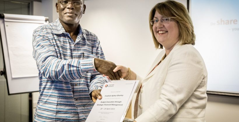A man accepting a certificate from a woman at a training event.