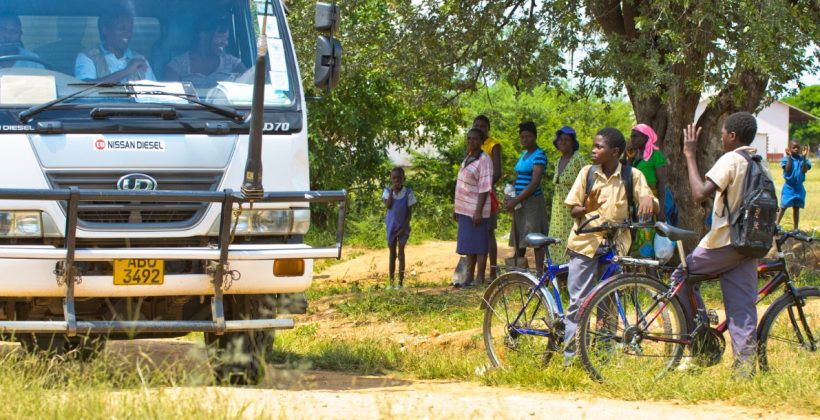 Children looking at a delivery truck in Zimbabwe.