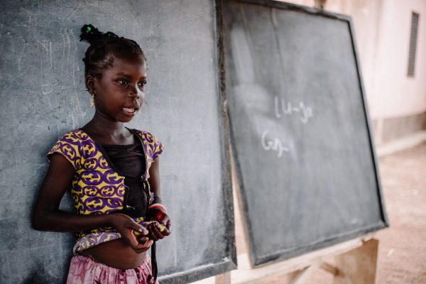A student participates in a lesson at her community school