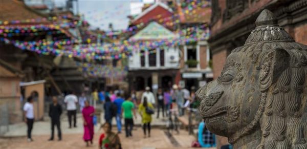 A statue and a busy street in Nepal.